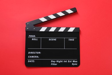 Photo of Clapperboard on red background, top view. Film industry