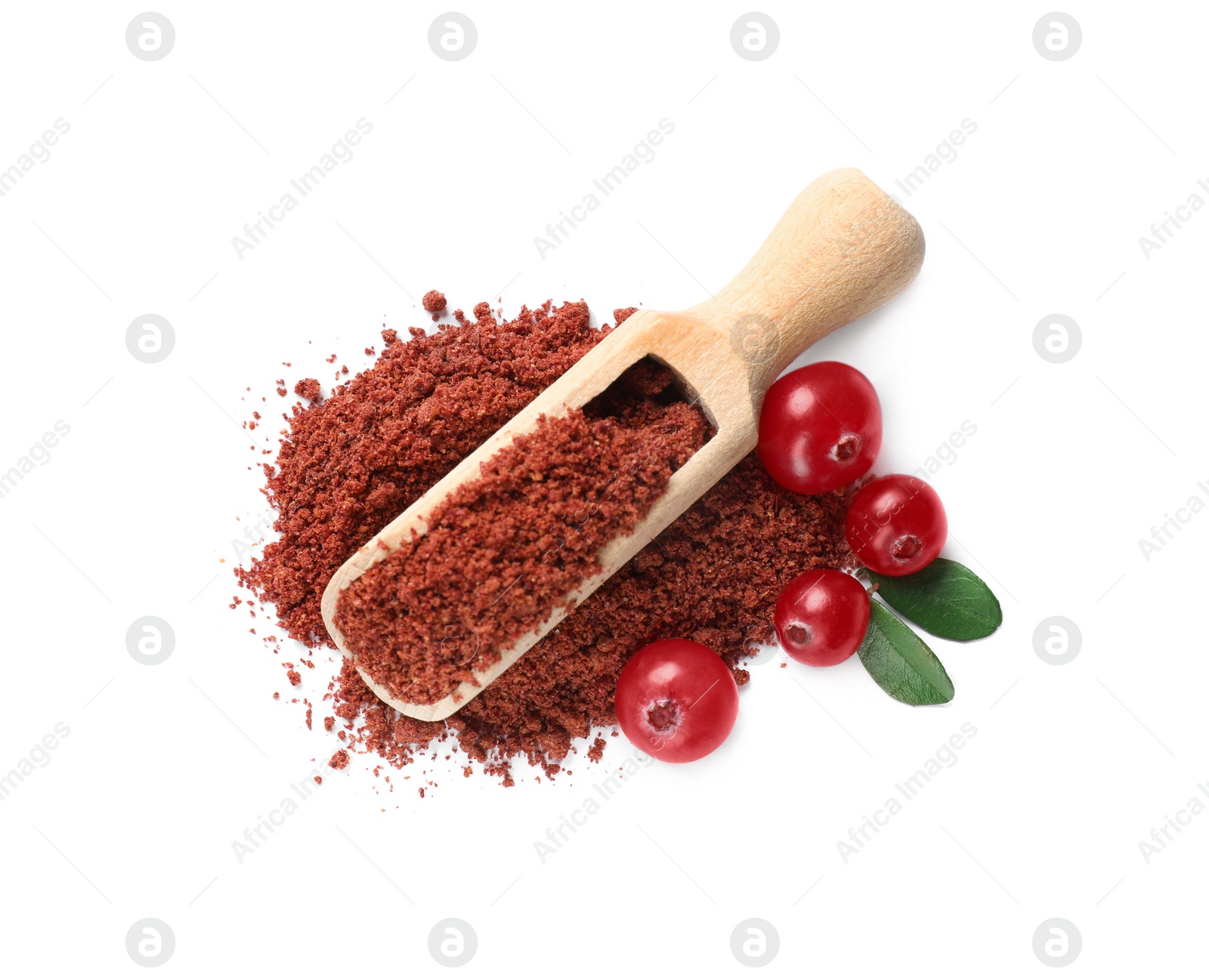 Photo of Wooden scoop with dried cranberry powder, fresh berries and green leaves isolated on white, top view