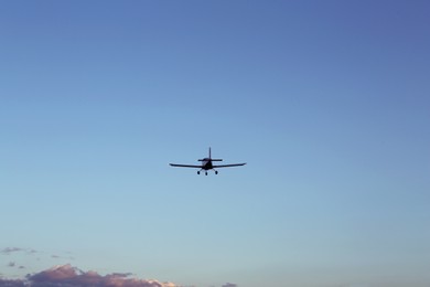 Photo of Modern ultralight airplane flying in blue sky