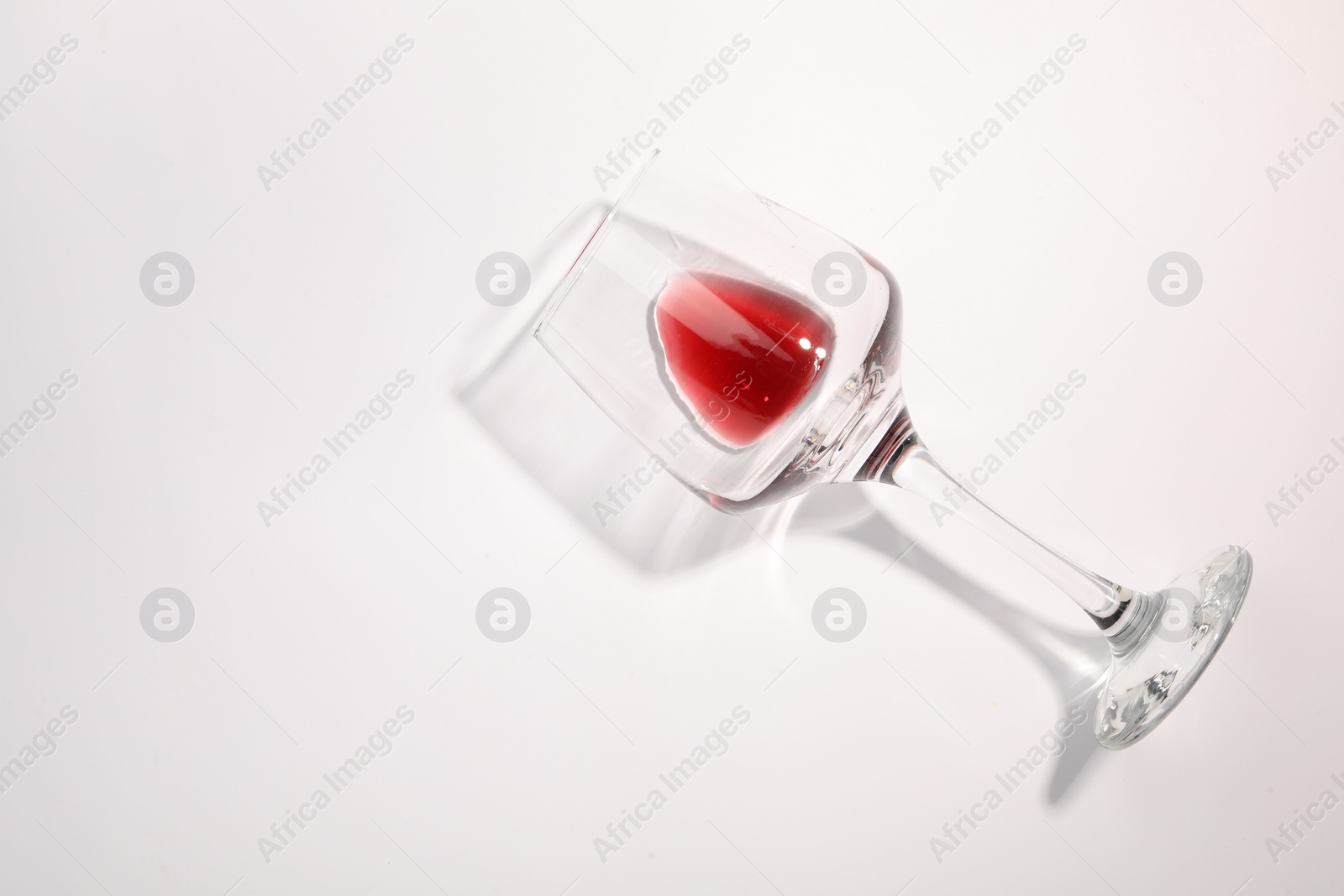 Photo of Tasty red wine in glass isolated on white, top view