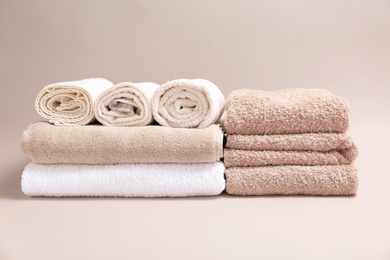 Soft bath towels on grey background