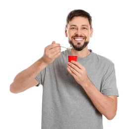 Photo of Handsome man with tasty yogurt on white background
