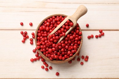 Photo of Aromatic spice. Red pepper in bowl and scoop on white wooden table, top view