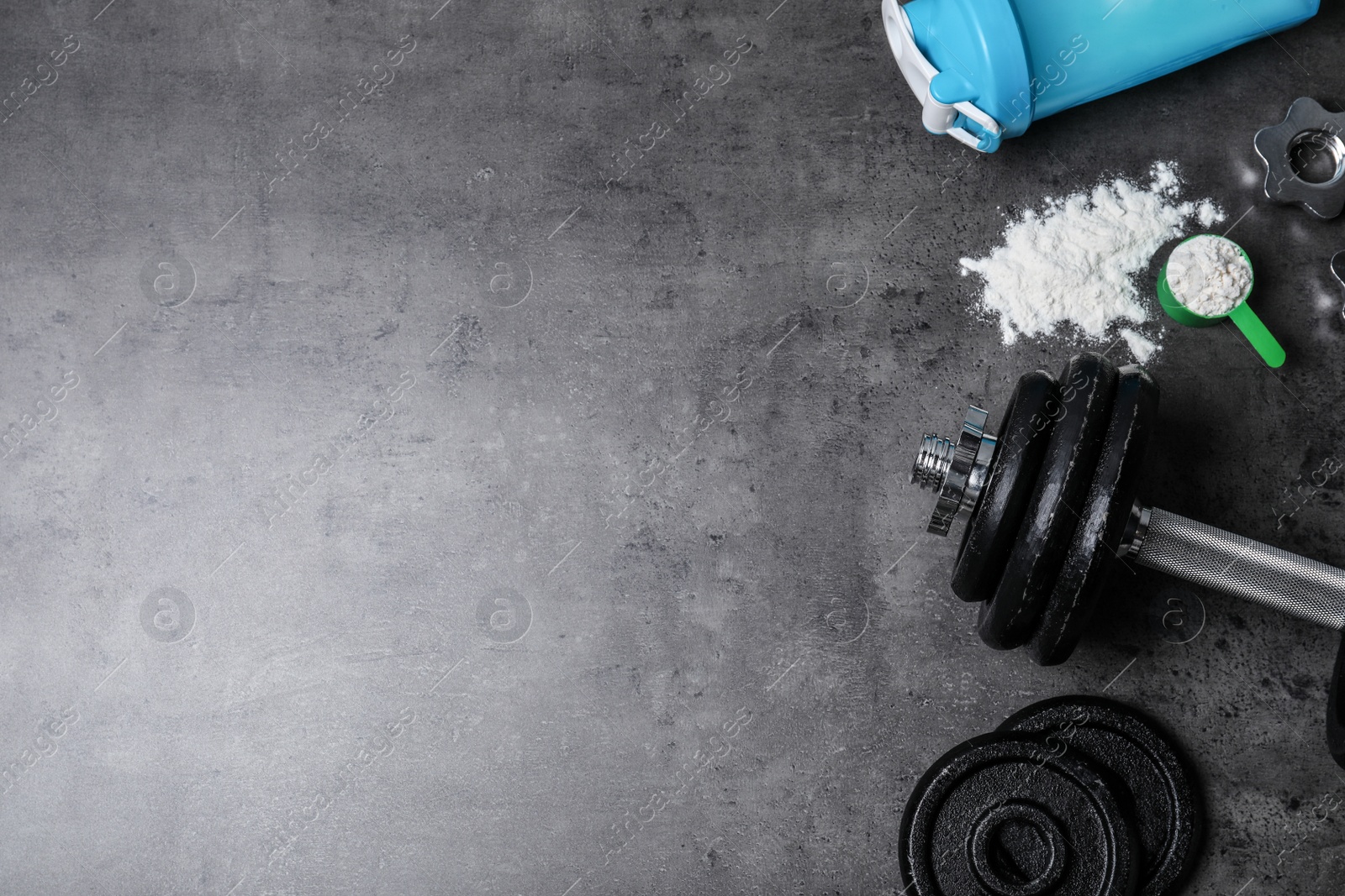 Photo of Flat lay composition with protein powder and fitness equipment on grey background. Space for text