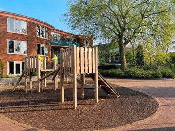 Outdoor playground for children near house on sunny day