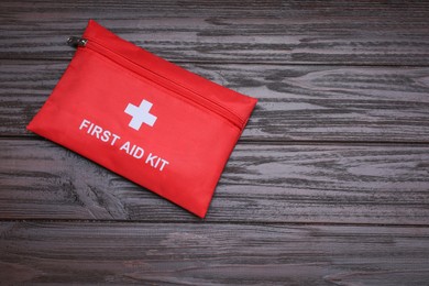 Photo of Medicine bag on wooden table, top view with space for text. First aid kit