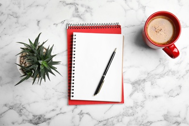 Photo of Flat lay composition with notebooks and coffee on marble background