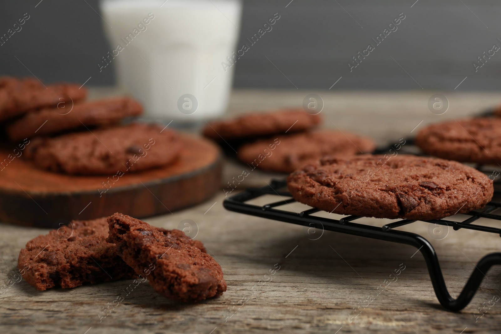 Photo of Delicious chocolate chip cookies on wooden table, closeup. Space for text