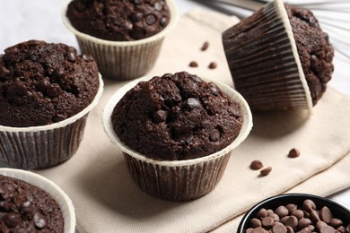 Tasty chocolate muffins on table, closeup view