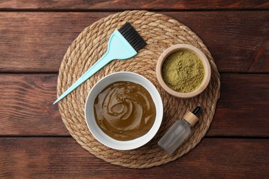 Composition with henna powder and cream on wooden table, top view. Natural hair coloring