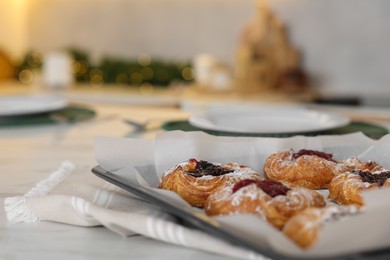 Tasty Christmas cookies on white marble table in kitchen, closeup. Space for text