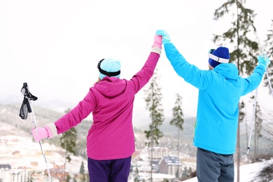 Couple on slope at resort. Winter vacation