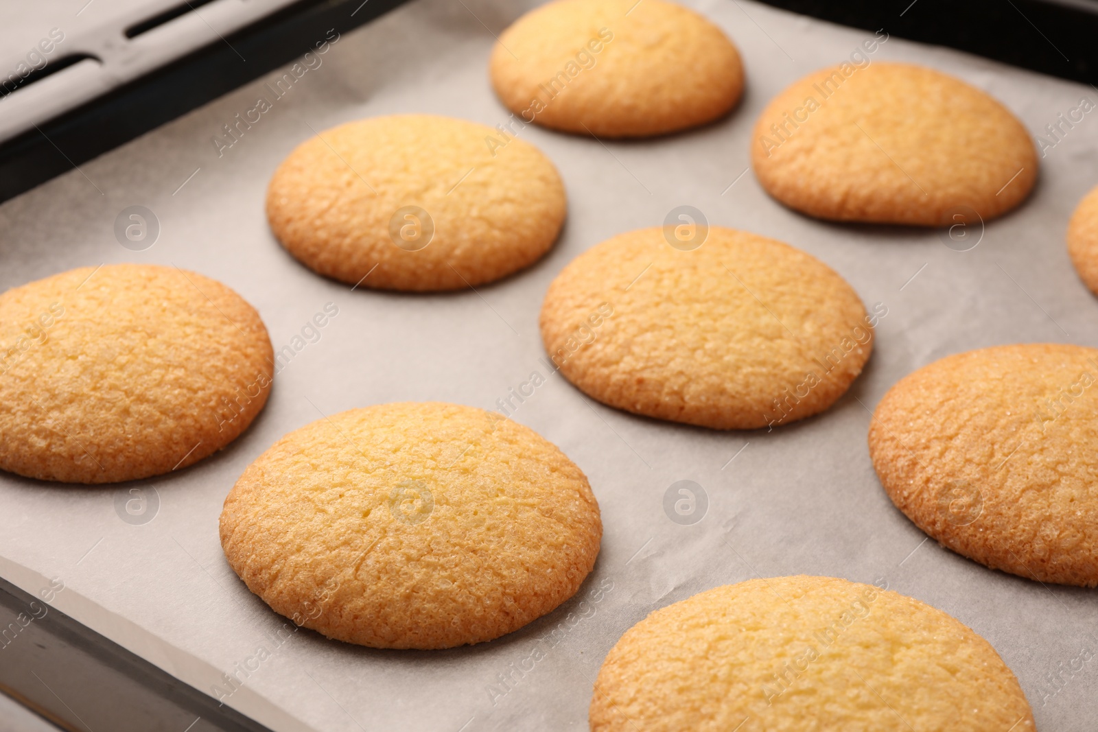 Photo of Delicious Danish butter cookies on baking tray, closeup