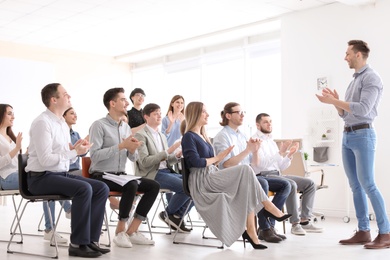 Photo of Male business trainer giving lecture in office
