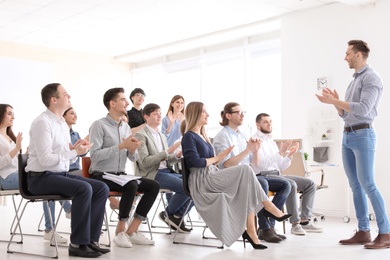 Male business trainer giving lecture in office