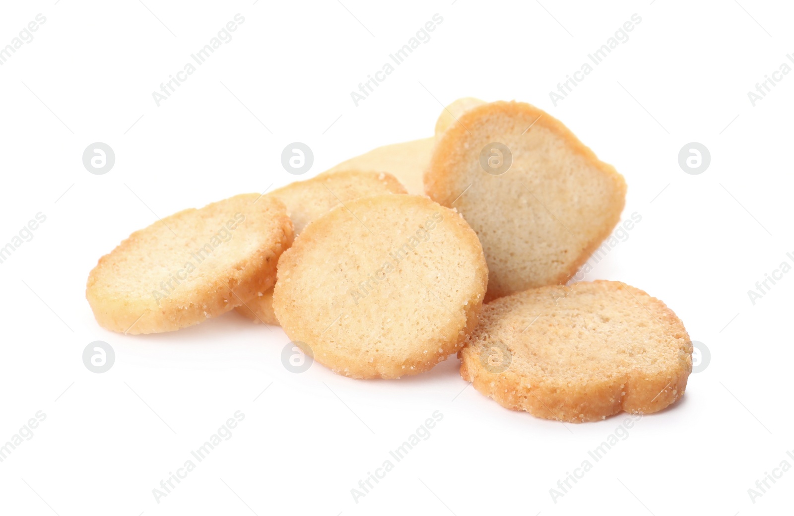 Photo of Pile of delicious crispy rusks on white background