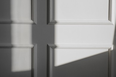 Photo of Light and shadow from window on beige wall indoors