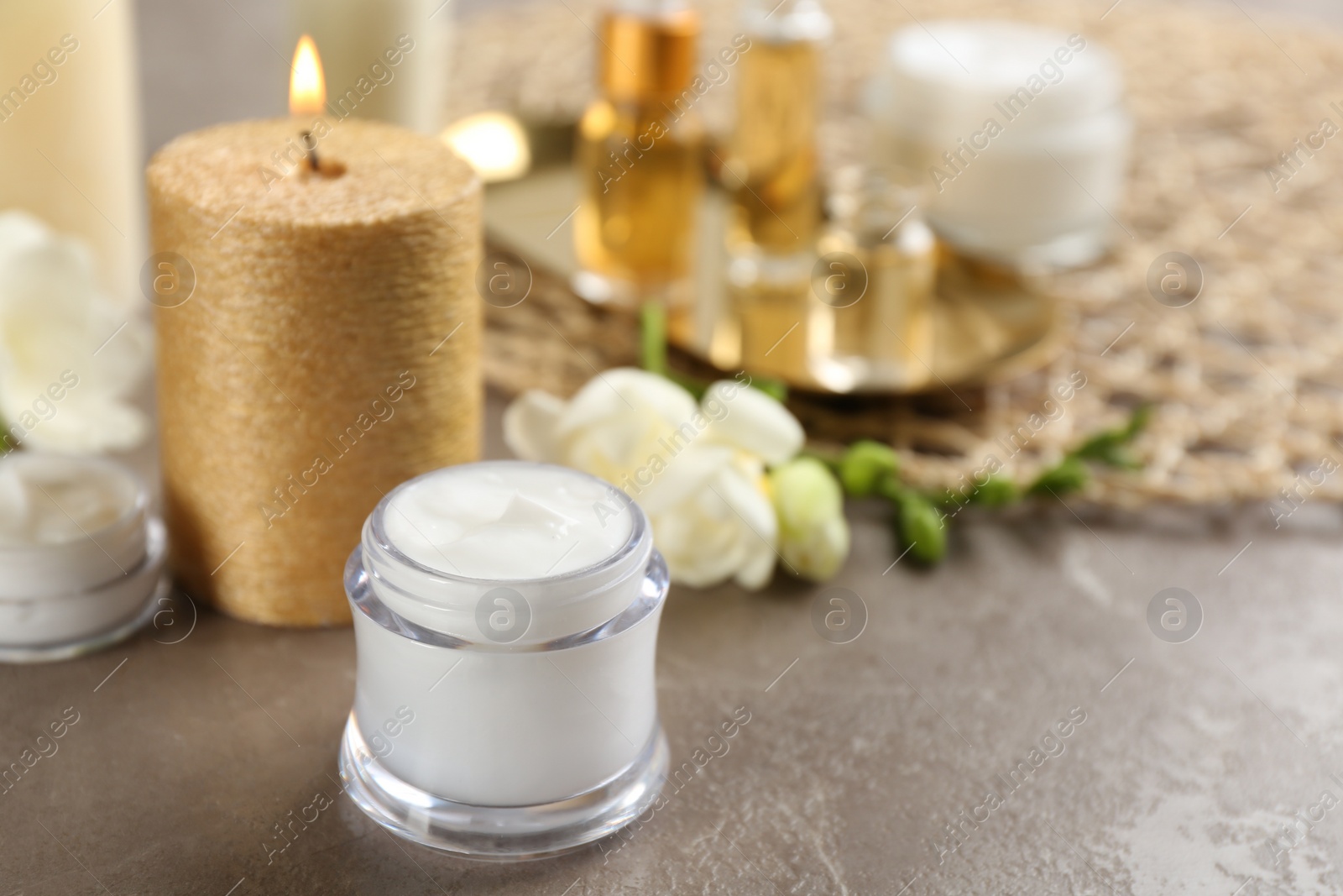 Photo of Beautiful spa composition with cosmetic products and candle on table. Space for text