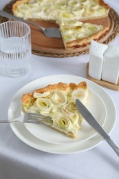 Piece of tasty leek pie served on table