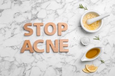 Phrase "Stop acne" and homemade problem skin remedy ingredients on light background