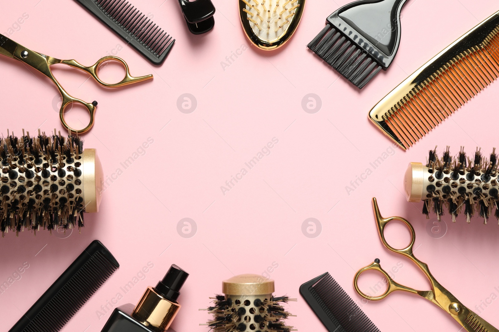 Photo of Frame made of professional hair dresser tools on pink background, flat lay. Space for text