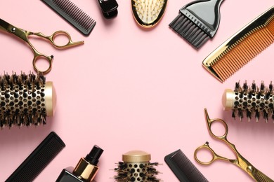 Photo of Frame made of professional hair dresser tools on pink background, flat lay. Space for text