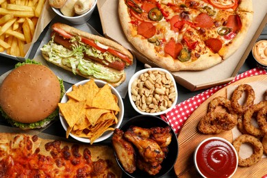 Photo of Pizza, chips and other fast food as background, top view