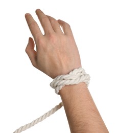 Photo of Freedom concept. Man with tied rope on his hand against white background, closeup