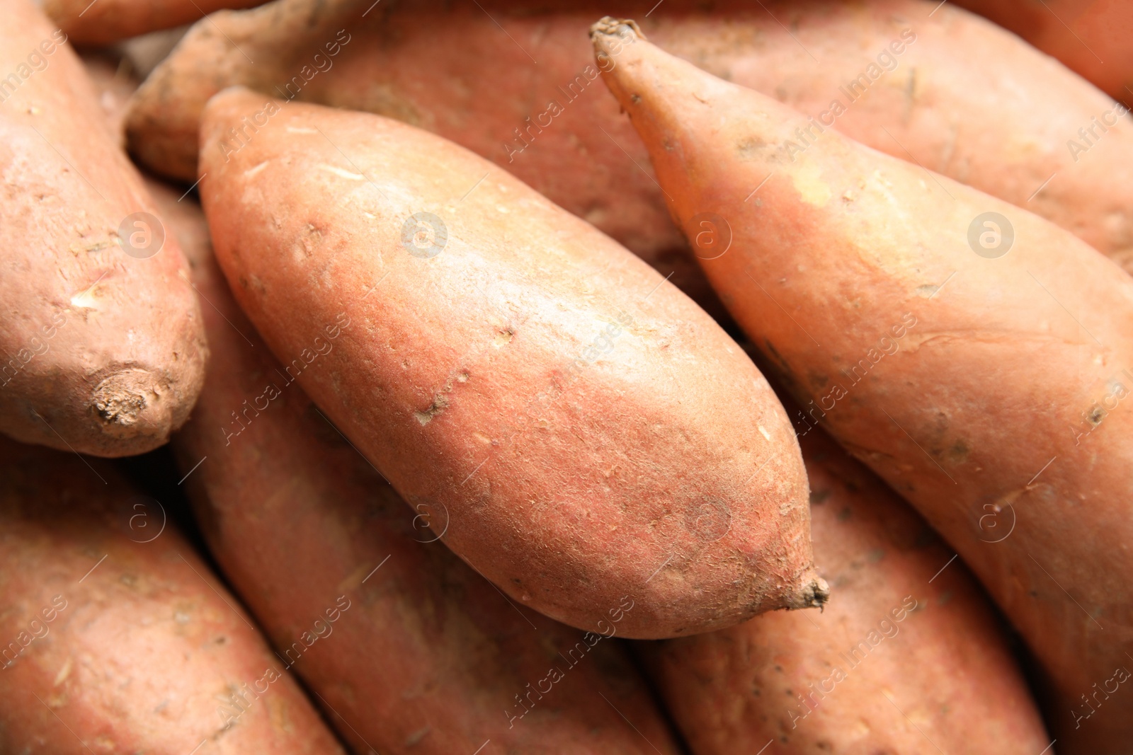 Photo of Pile of sweet potatoes as background, top view