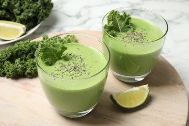 Photo of Tasty kale smoothie on marble table, closeup