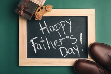 Photo of Flat lay composition with blackboard, gift boxes and shoes on color background. Happy Father's Day