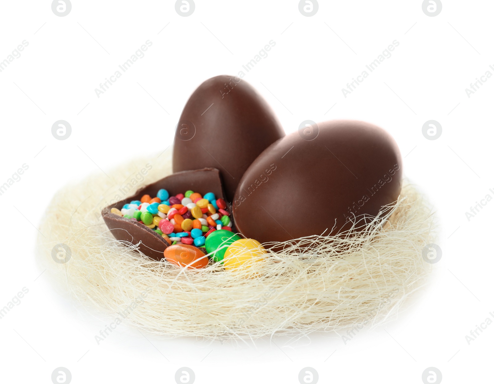 Photo of Chocolate Easter eggs in decorative nest on white background