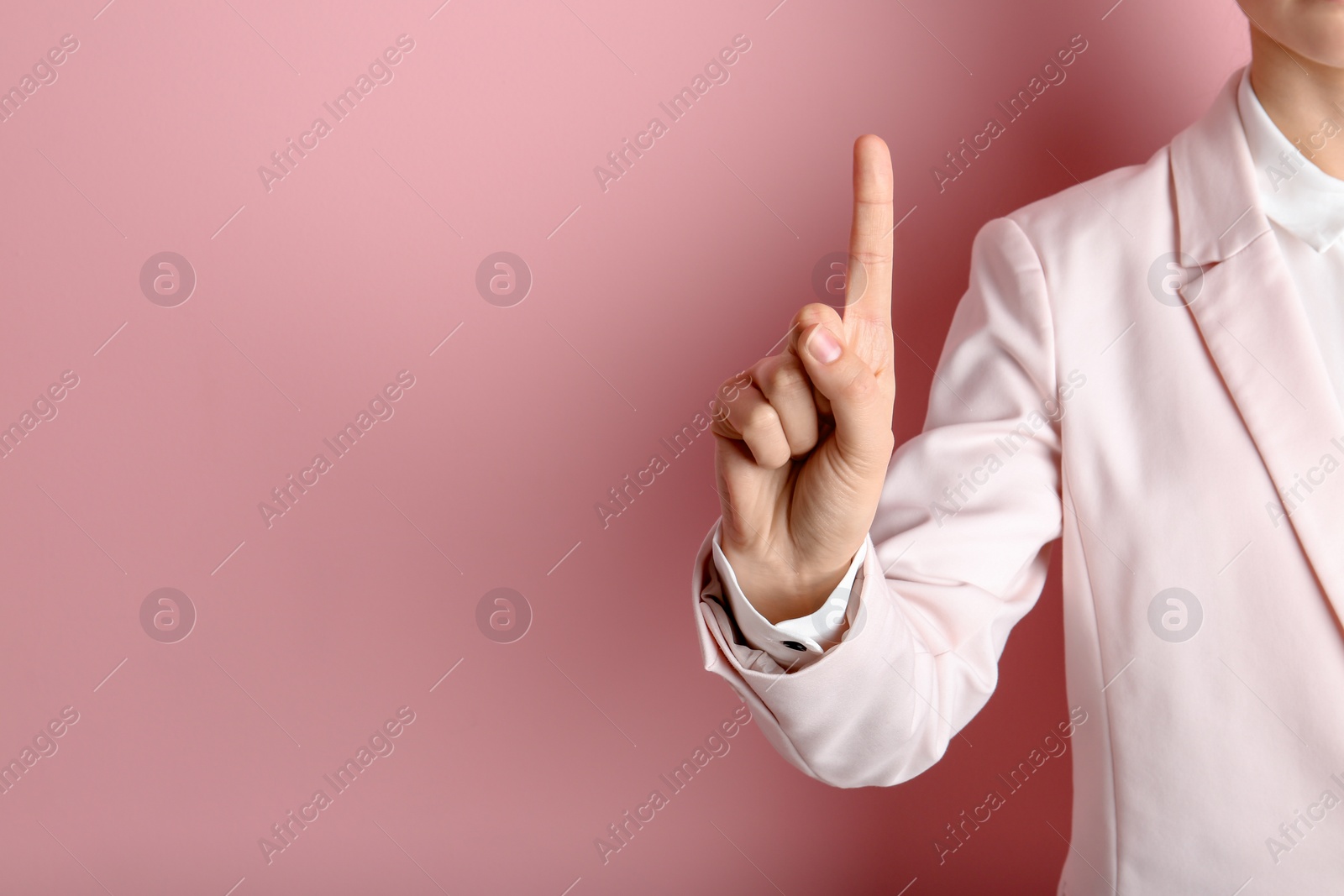 Photo of Young woman with raised index finger on color background. Space for text