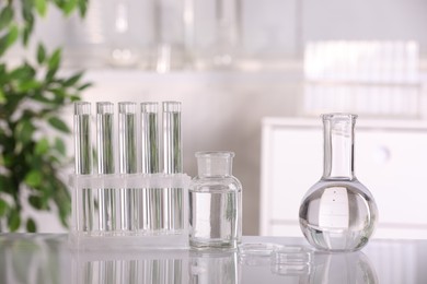 Laboratory analysis. Different glassware with liquid on white table indoors