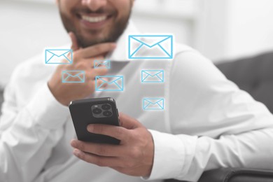 Image of Smiling man with smartphone chatting indoors, closeup. Many illustrations of envelope as incoming messages over device