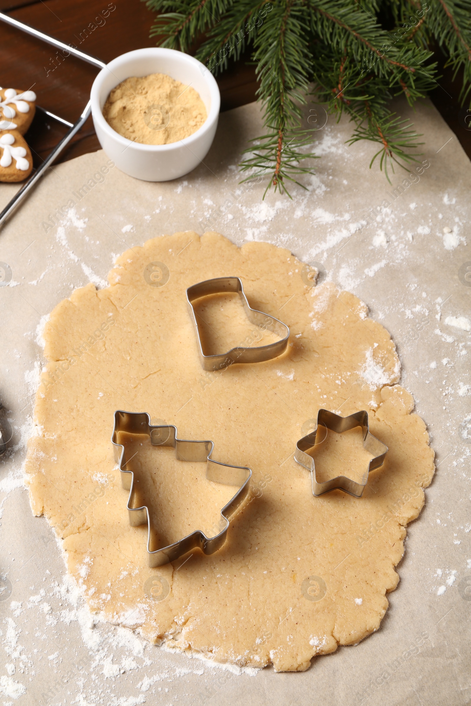 Photo of Making Christmas cookies. Raw dough and cutters on table, above view