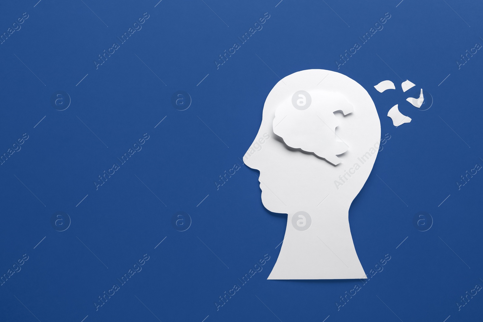 Photo of Human head with brain pieces made of paper on blue background, top view and space for text. Dementia concept