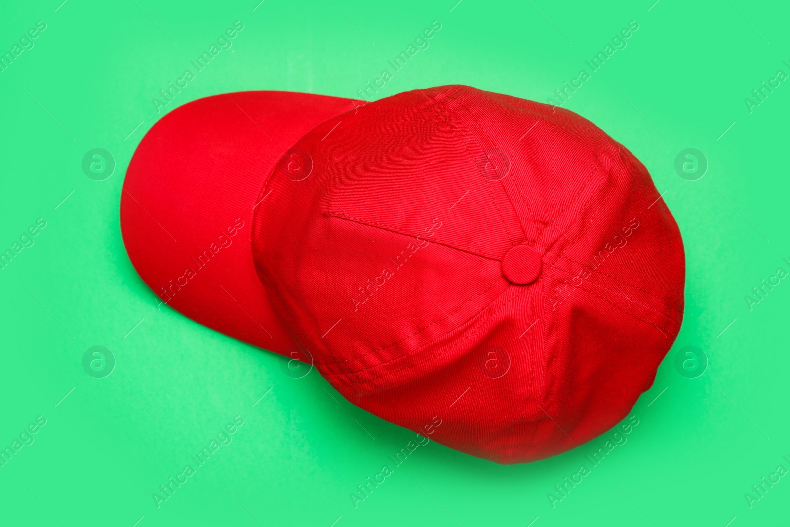 Photo of Baseball cap on green background, top view. Mock up for design