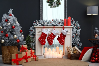 Fireplace with Christmas stockings in festive room interior