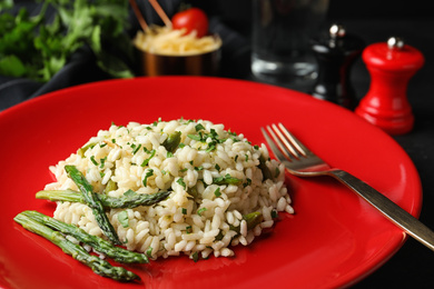 Delicious risotto with asparagus in plate, closeup