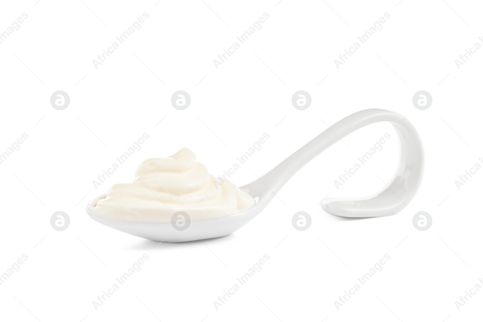 Photo of Serving spoon with sour cream on white background