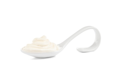 Photo of Serving spoon with sour cream on white background