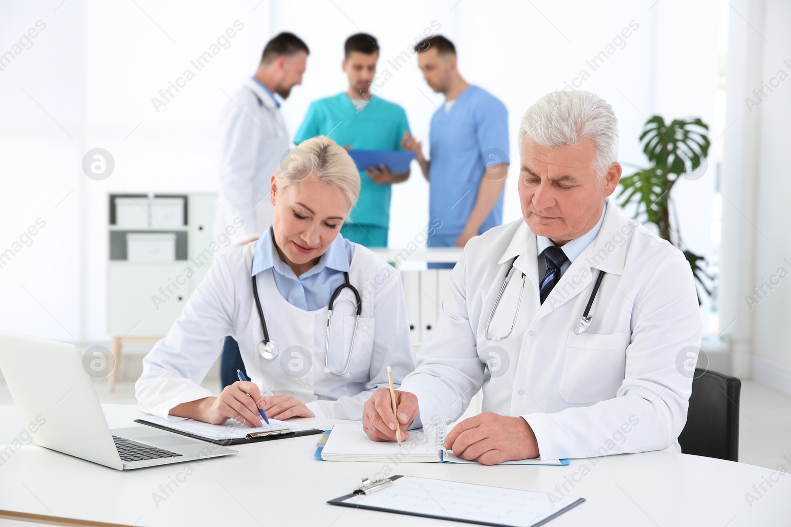 Photo of Group of doctors attending meeting in clinic. Cardiology conference