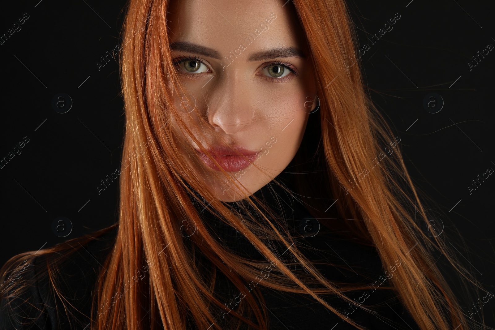 Photo of Evil eye. Young woman with scary eyes on black background