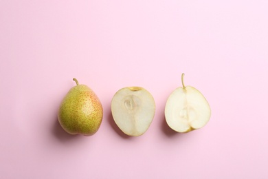 Ripe juicy pears on pink background, flat lay. Space for text