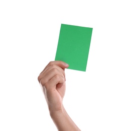 Photo of Football referee holding green card on white background, closeup