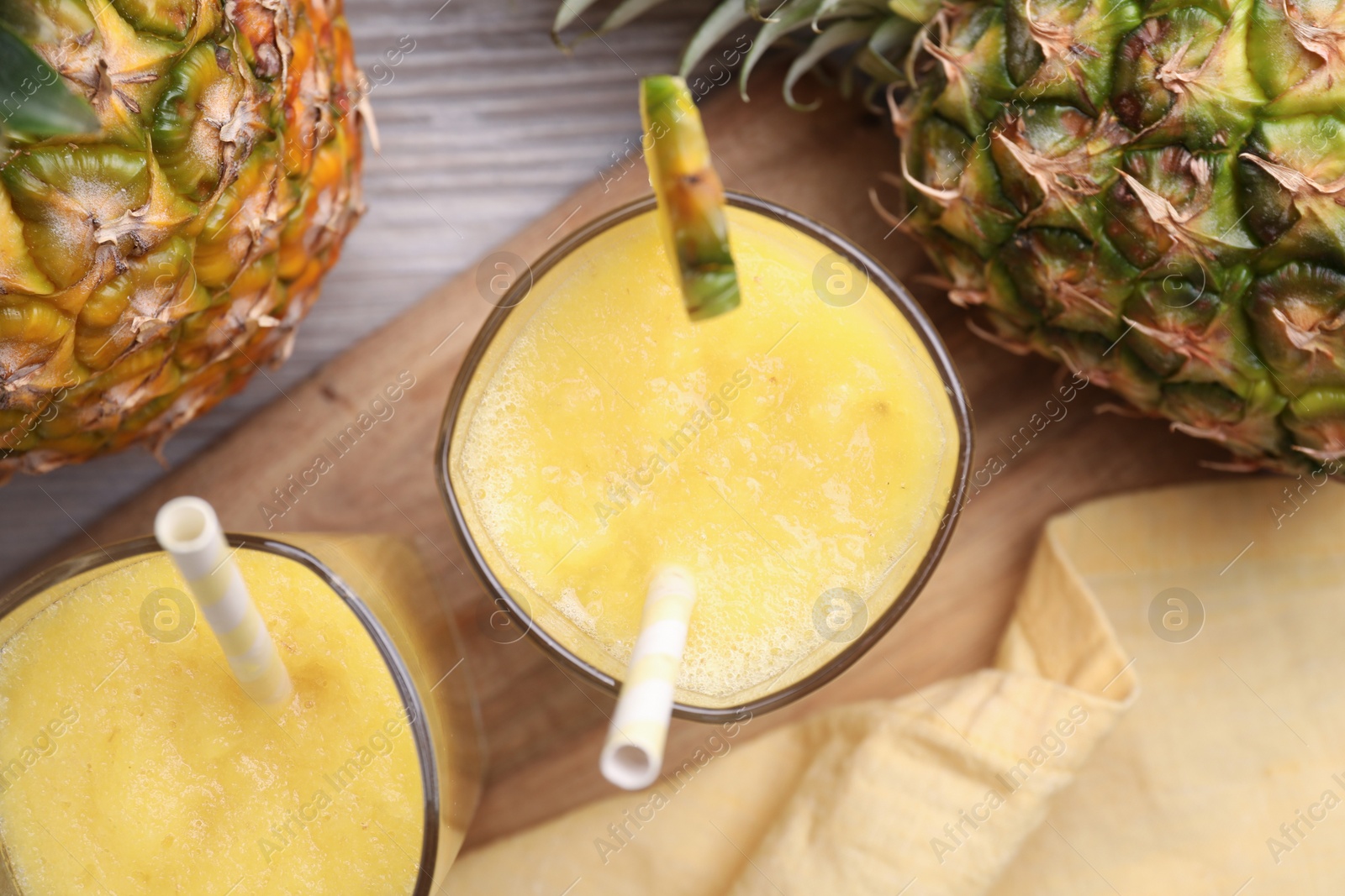 Photo of Tasty pineapple smoothie and fresh fruits on table, flat lay