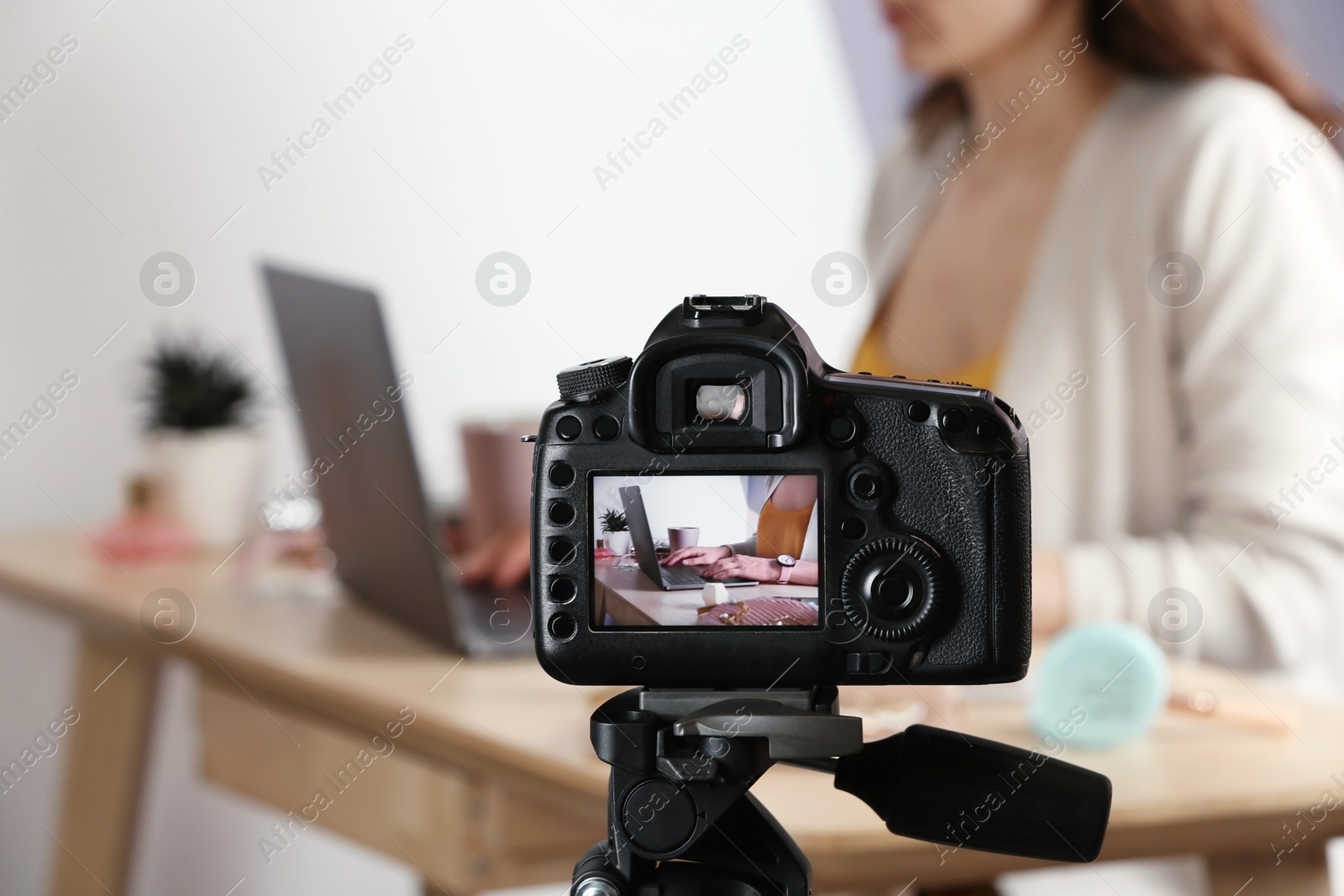 Photo of  blogger at workplace on camera screen, closeup with space for text