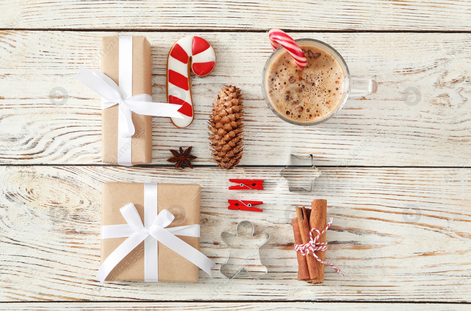 Photo of Flat lay composition with Christmas gift boxes and decor on white wooden table