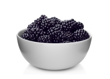 Ceramic bowl of tasty ripe blackberries on white background